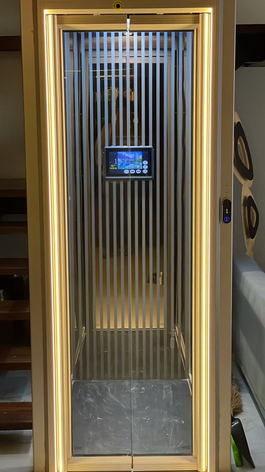 The car seen through its open landing door, lit by the frame’s warm LED strips